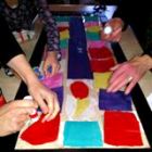 A tissue paper stained glass window being made